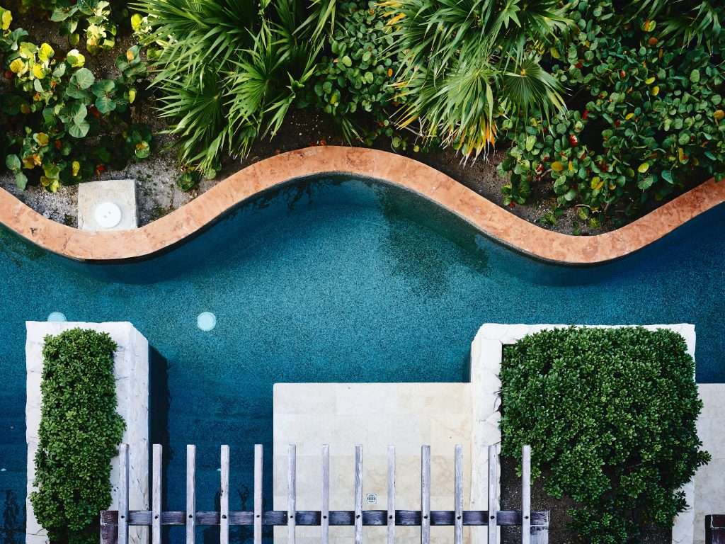 a white concrete house beside a pool