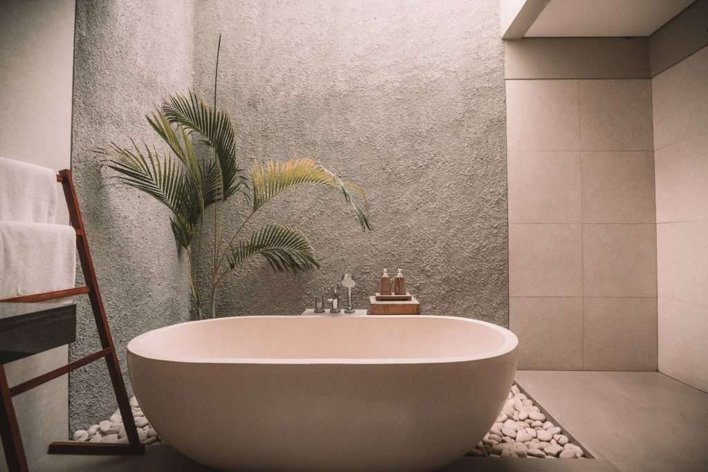 a spa-like bathroom with a white ceramic bathtub