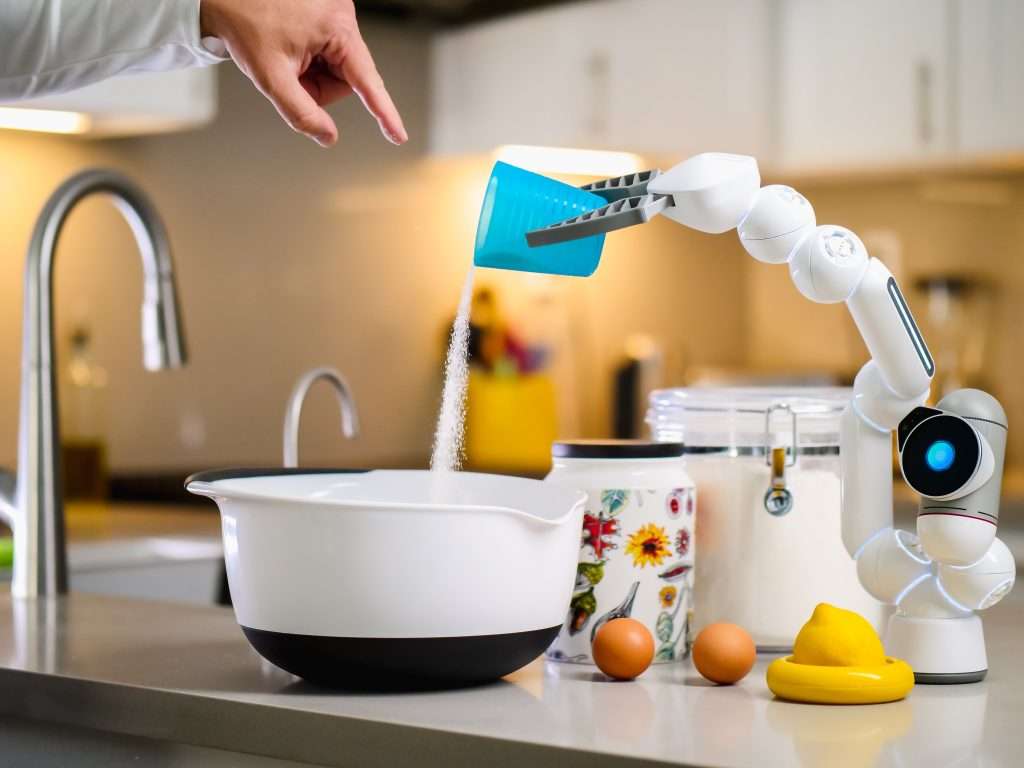 a robot hand pouring flour into a white bowl
