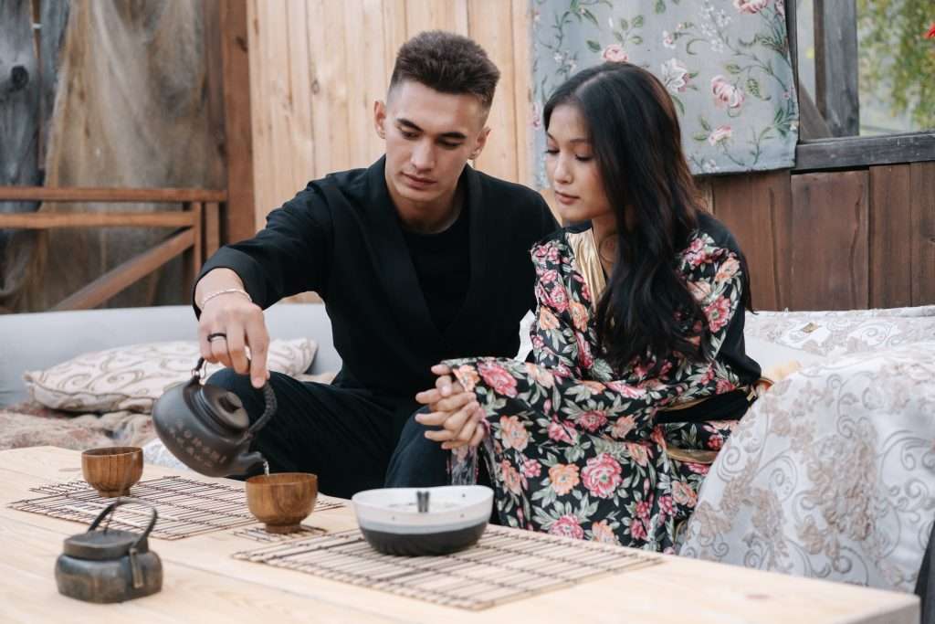 a Japanese couple enjoying tea inside a Japanese wooden interior