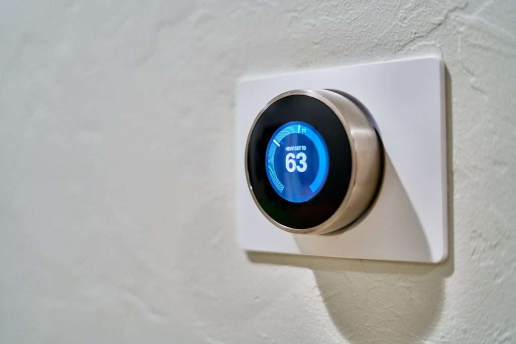 a grey thermostat displaying 63